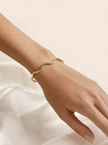 Woman wearing gold wavy cuff bracelet