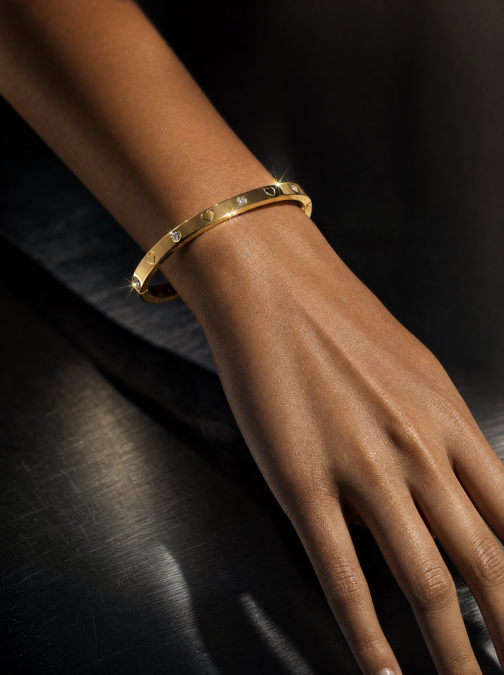 Gold heart bangle sparkling on wrist