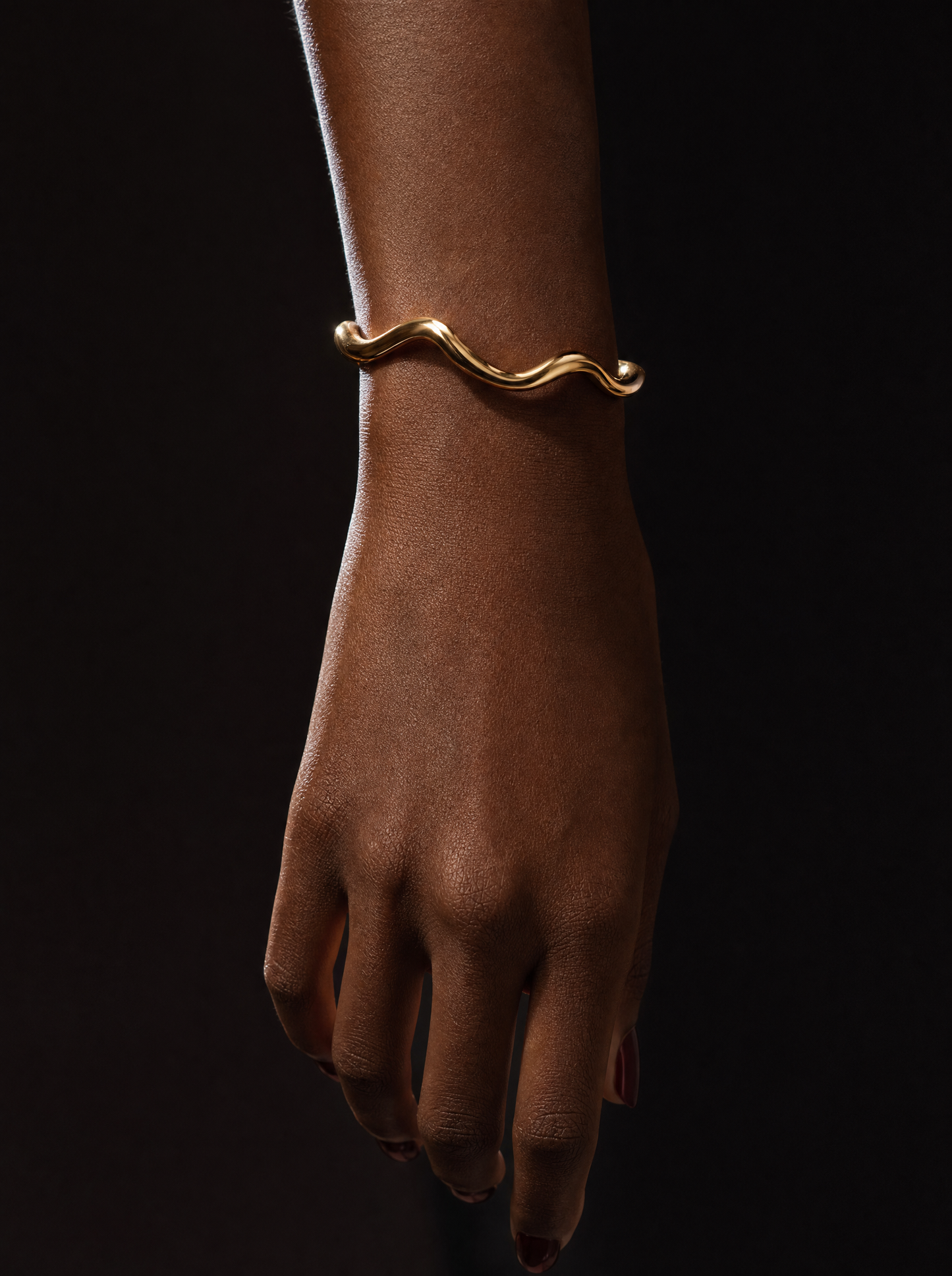 Gold wave cuff bracelet on wrist