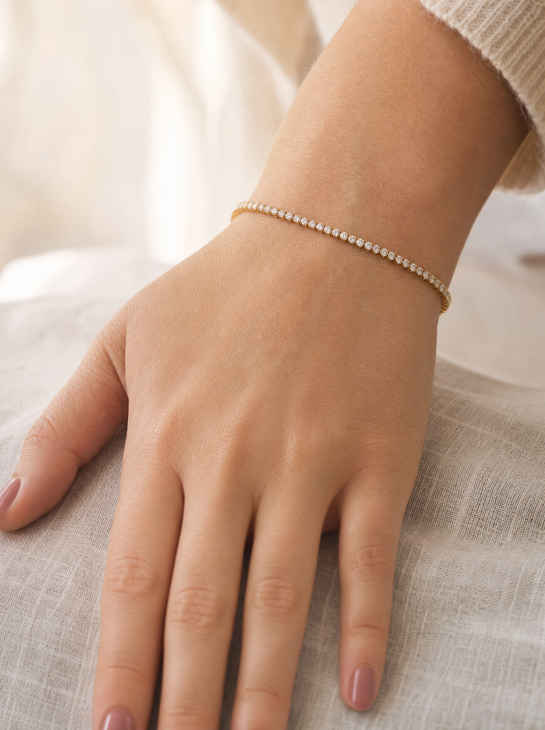 Diamond tennis bracelet on wrist, warm lifestyle light
