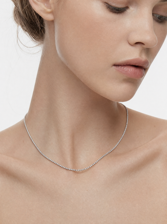 Womens dainty tennis necklace on model, close crop