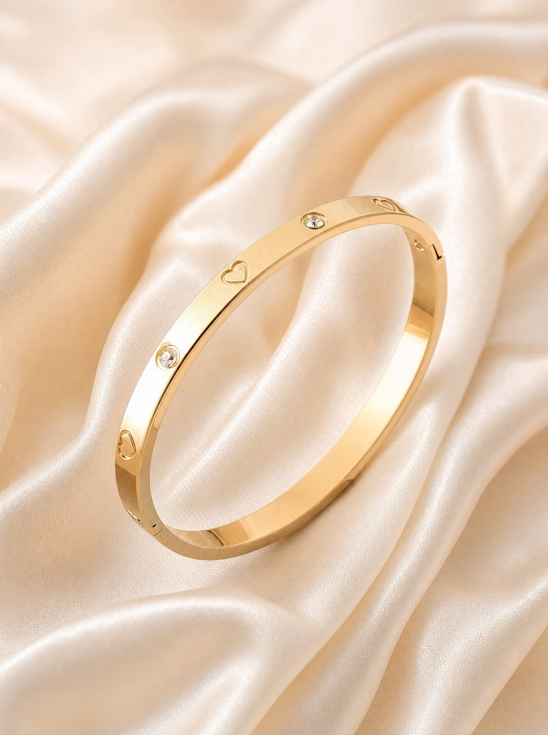 Heart bangle bracelet, 18K gold plated with crystal accents, flat lay detail