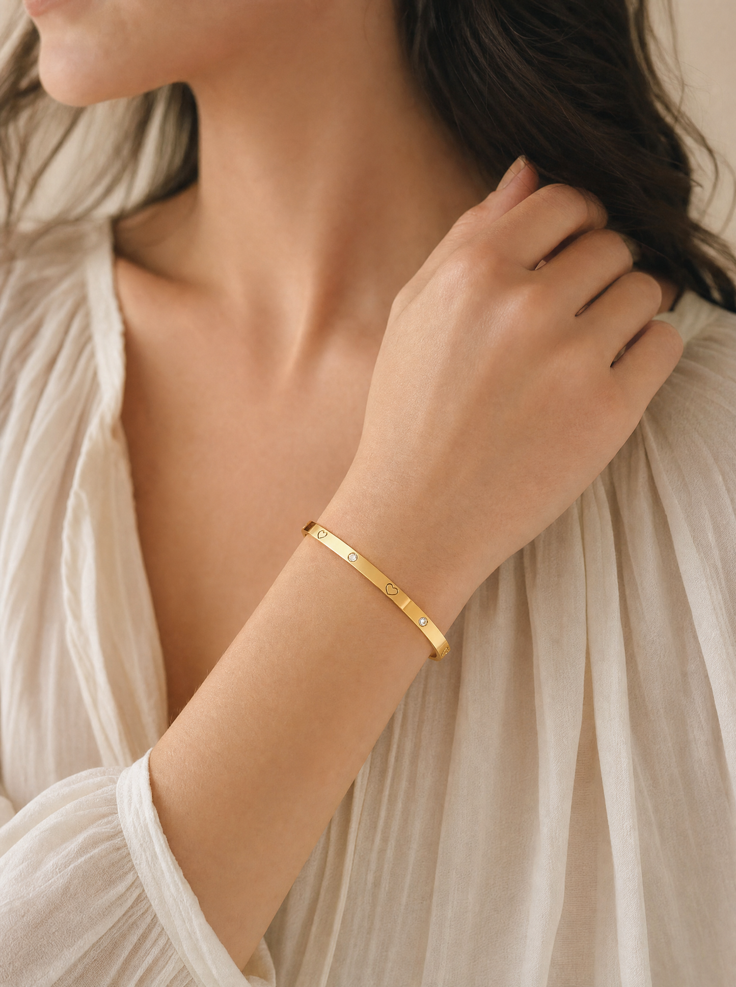 Heart bangle bracelet, 18K gold plated with crystal accents, on-wrist detail angle