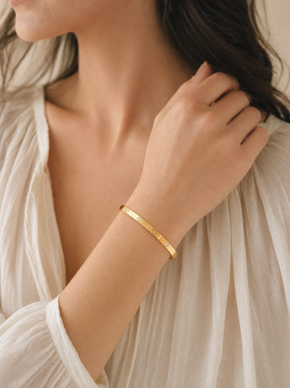 Heart bangle bracelet, 18K gold plated with crystal accents, on-wrist detail angle