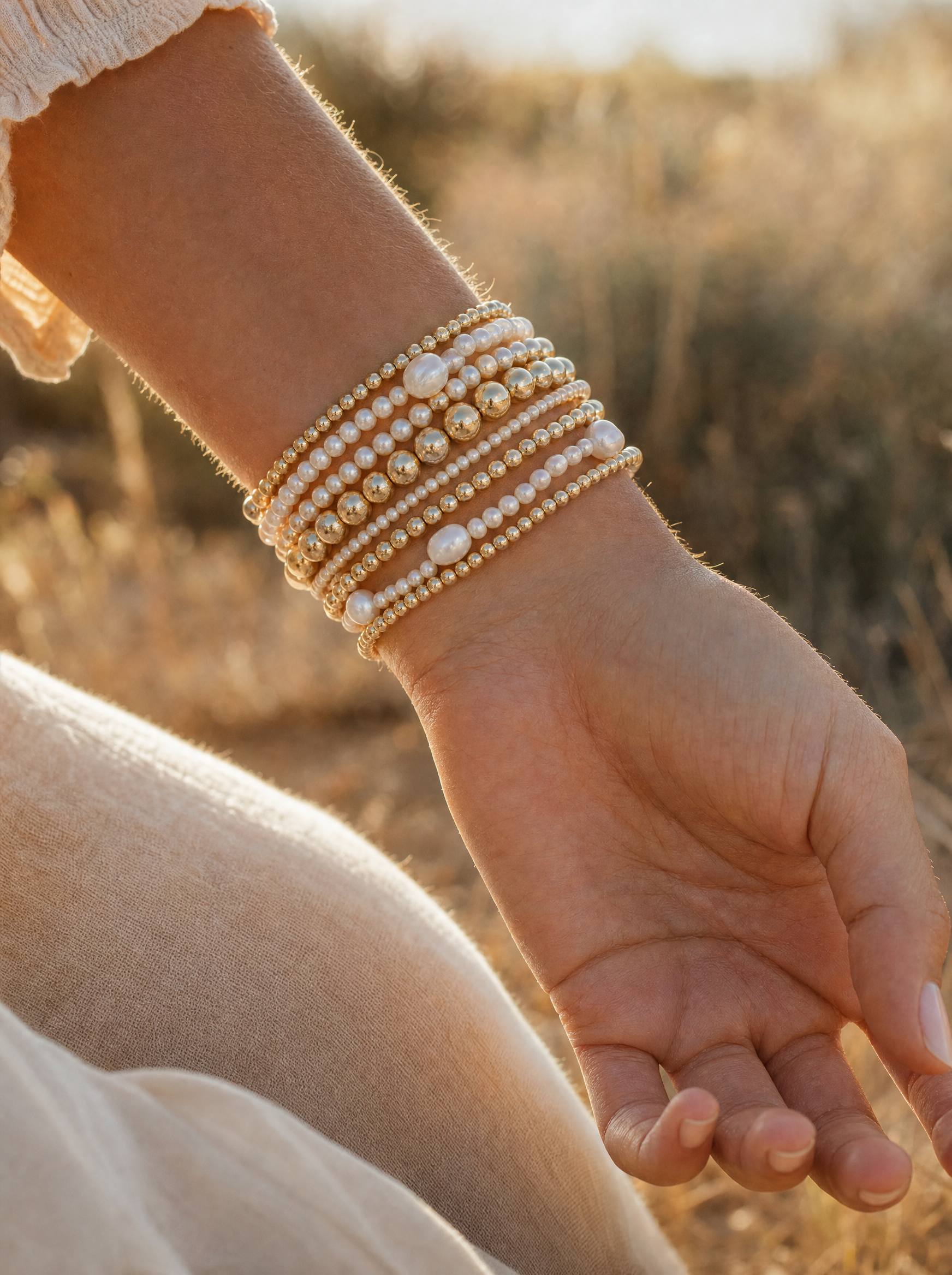 Pearl and gold bracelet stack in natural light