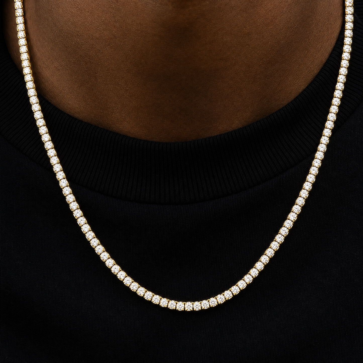 Close-up of 18K gold plated simulated diamond tennis chain prongs and stones