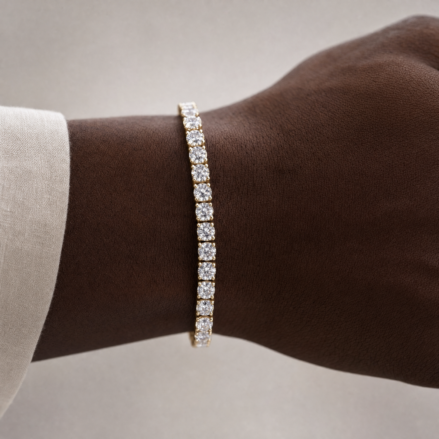Simulated diamond tennis bracelet in 18K gold plating, worn on wrist
