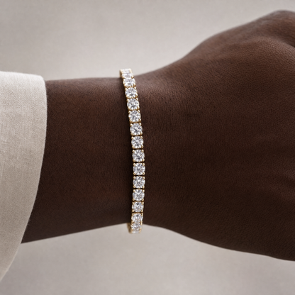 Simulated diamond tennis bracelet in 18K gold plating, worn on wrist