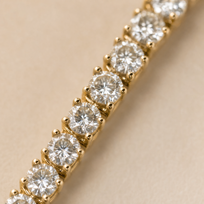 Close-up of 18K gold plated simulated diamond tennis bracelet prongs and stones