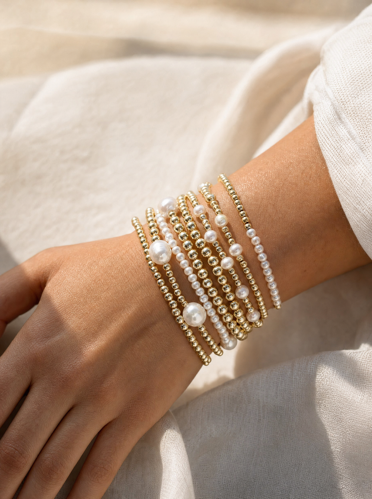 Pearl and gold bead stackable bracelet set, on-wrist detail angle