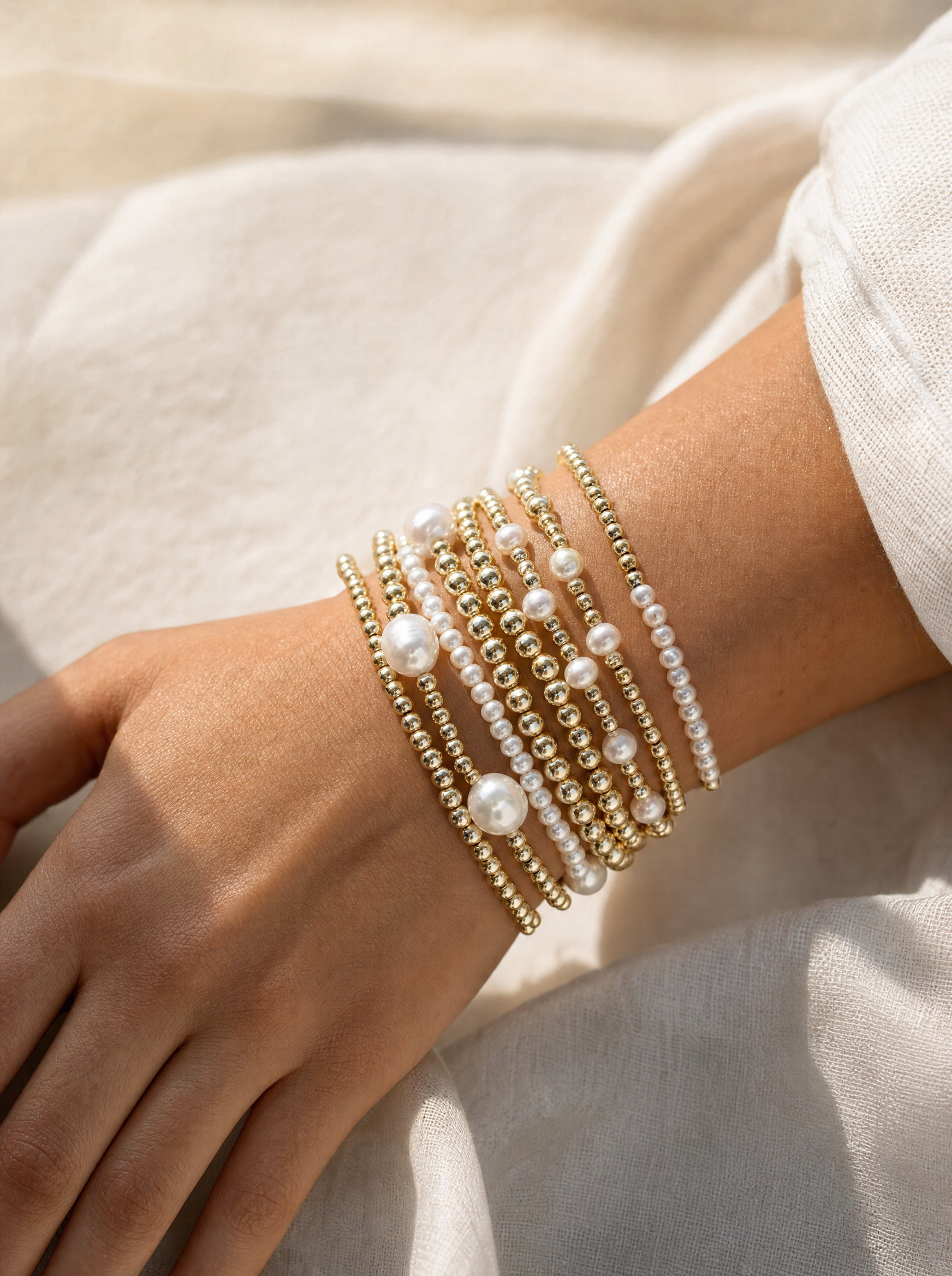 Pearl and gold bead stackable bracelet set, on-wrist detail angle